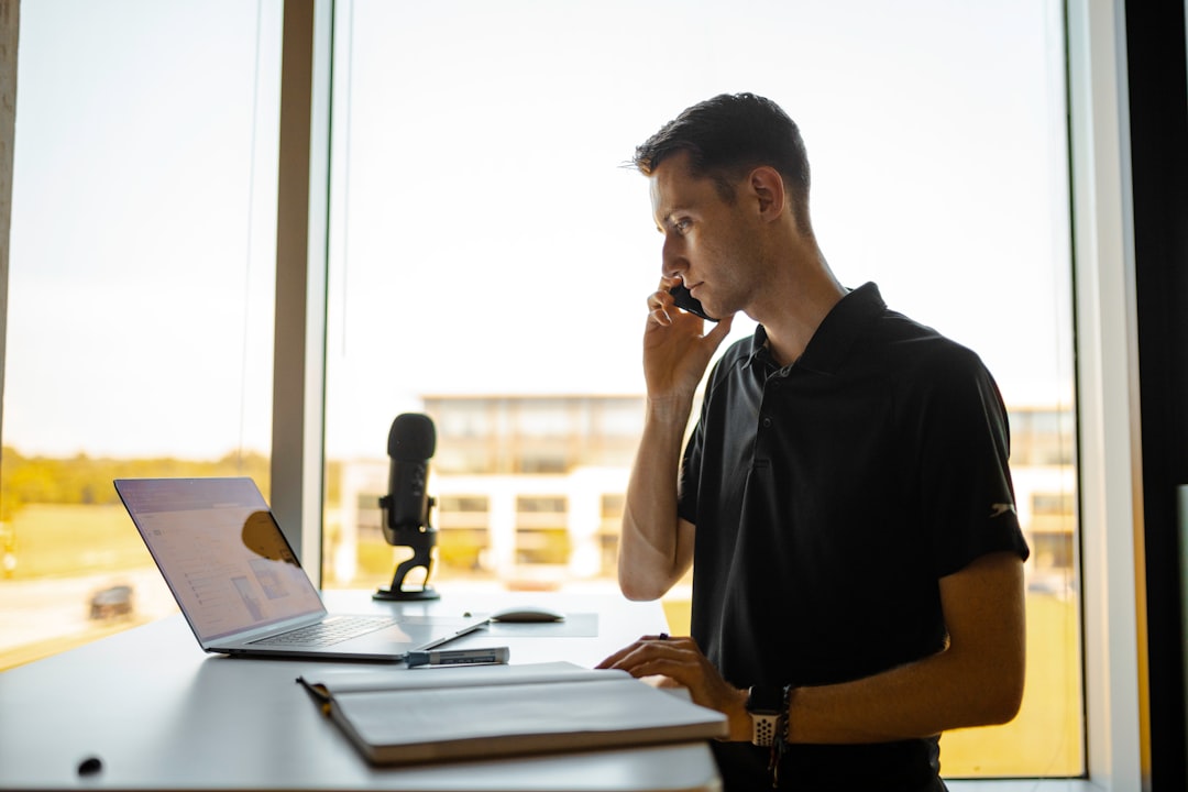 Sales rep on a phone call at his desk, representing real-time coaching during live sales conversations instead of static LMS training