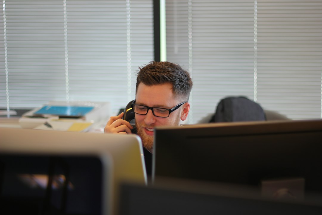 Sales rep on a call taking notes, working through a buyer objection
